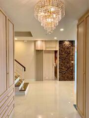 Elegant hallway with chandelier and staircase