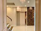 Elegant hallway with chandelier and staircase