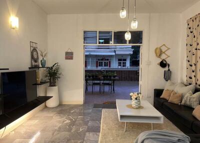 Spacious living room with modern decor and a view of the patio