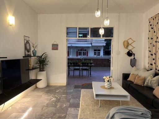 Spacious living room with modern decor and a view of the patio