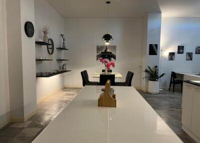 Modern dining area with a table, pendant light, and wall decor