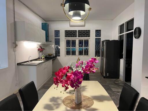 Modern kitchen with dining table and flowers