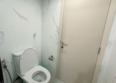 Modern bathroom with toilet and marble walls