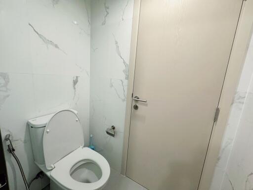 Modern bathroom with toilet and marble walls