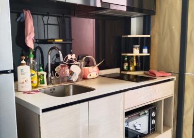 Modern kitchen with beige cabinets and stainless steel sink