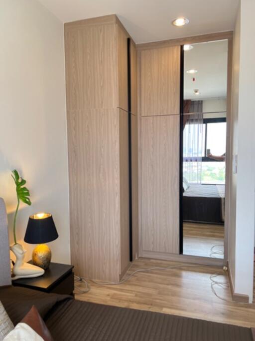 Bedroom with a wooden wardrobe and a mirror