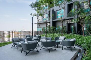 Modern outdoor seating area with gray chairs and a scenic view