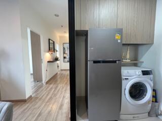 Laundry area with washer and refrigerator