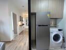 Laundry area with washer and refrigerator