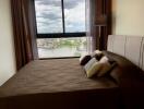 Bedroom with large window and city view