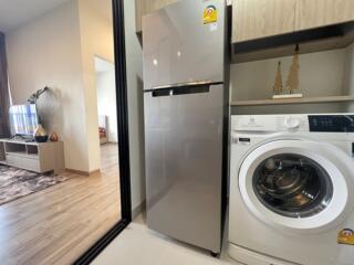 Modern kitchen with fridge and washing machine