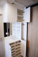 Photo of an entrance area with storage cabinets and hooks