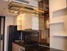 Modern kitchen with black granite countertops and gold shelving