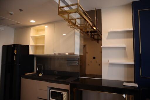 Modern kitchen with black and white cabinetry and gold accents