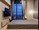 Modern bedroom with large window and city view