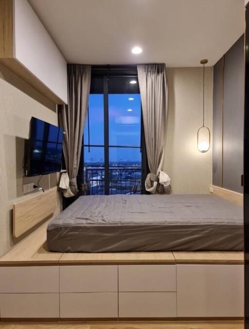 Modern bedroom with large window and city view