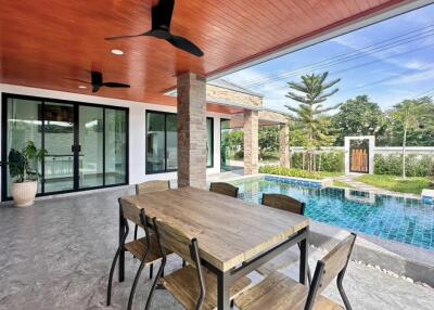 Outdoor patio with wooden ceiling and pool view