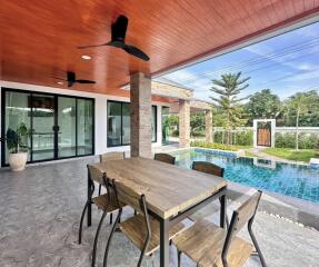 Outdoor patio with wooden ceiling and pool view