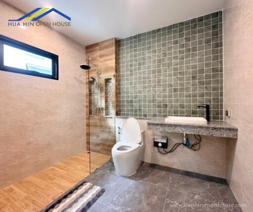 Modern bathroom with shower, toilet, and vanity