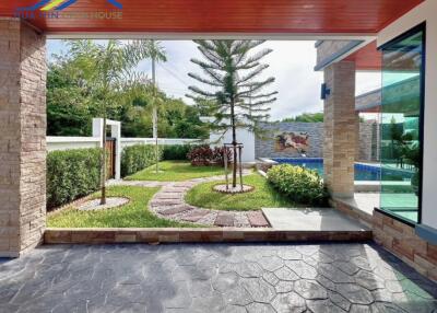 Well-maintained yard with green lawn and stone path