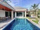 Modern house with outdoor swimming pool and patio area