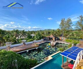 Outdoor recreational area with pool and lotus pond