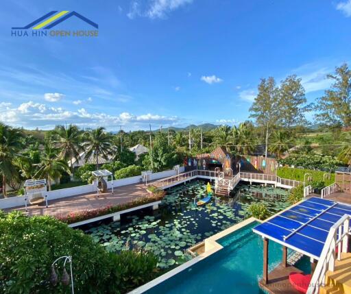 Outdoor recreational area with pool and lotus pond