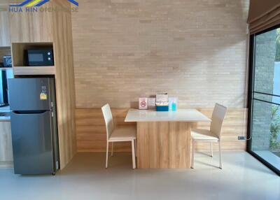 Modern kitchen dining area with wooden table and chairs