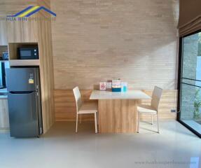 Modern kitchen dining area with wooden table and chairs