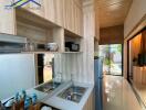 Modern kitchen with wooden finishes, double sink, and outdoor view