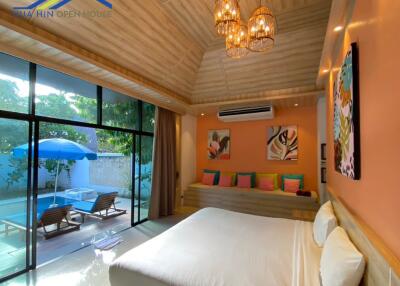 Spacious bedroom with pool view and natural lighting