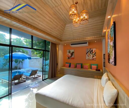 Spacious bedroom with pool view and natural lighting