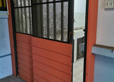 Red sliding door in a building with a view inside