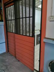 Red sliding door in a building with a view inside