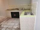 Basic kitchen with a sink and tiled countertops