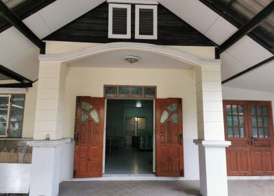 Front view of a house with prominent wooden double doors