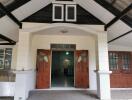 Front view of a house with prominent wooden double doors