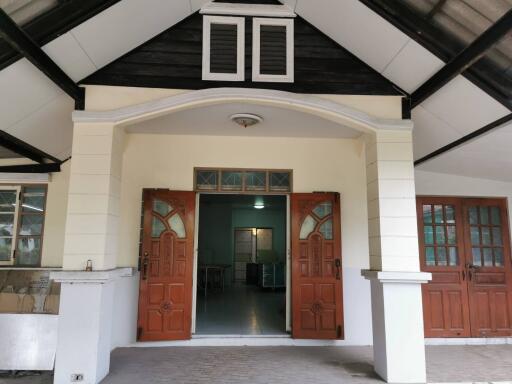 Front view of a house with prominent wooden double doors