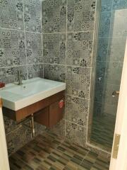 Bathroom with patterned tiles and sink