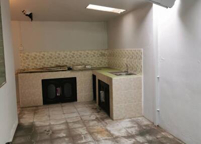 Small unfinished kitchen with tiled floor and countertop