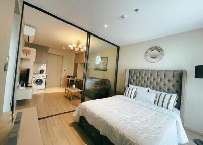 Modern bedroom with an attached living space and kitchen