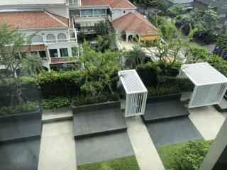 view of outdoor seating area with greenery