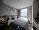 Modern bedroom with large window, world map wall decor, and cozy bedding