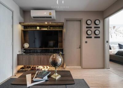 Modern living room with wall-mounted TV and globe on coffee table