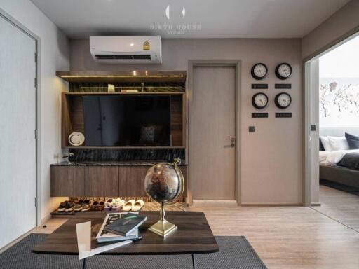 Modern living room with wall-mounted TV and globe on coffee table