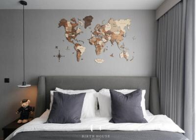 Bedroom with world map wall décor and plush bedding