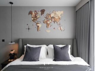 Bedroom with world map wall décor and plush bedding