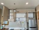 Modern kitchen with open cabinets and stainless steel fridge