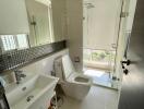 Modern bathroom with white fixtures and large mirror