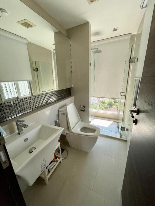 Modern bathroom with white fixtures and large mirror